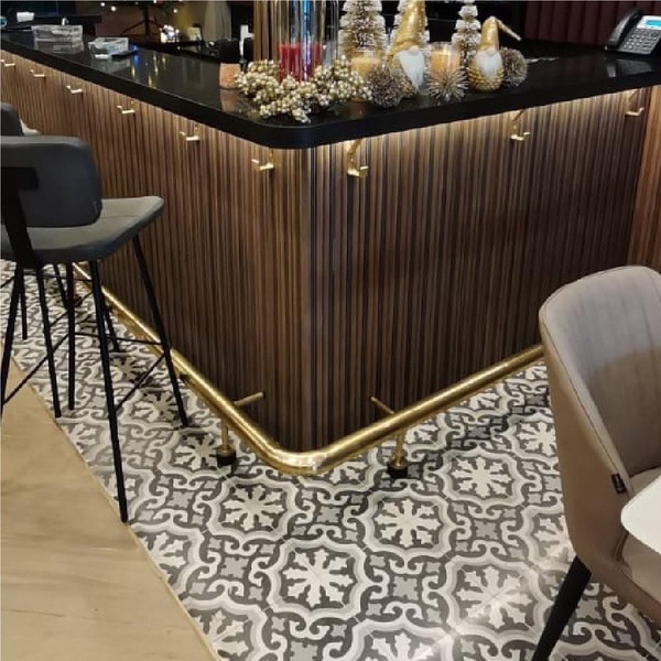 Patterned grey and white cement tile floor running through the Kababji restaurant bar area
