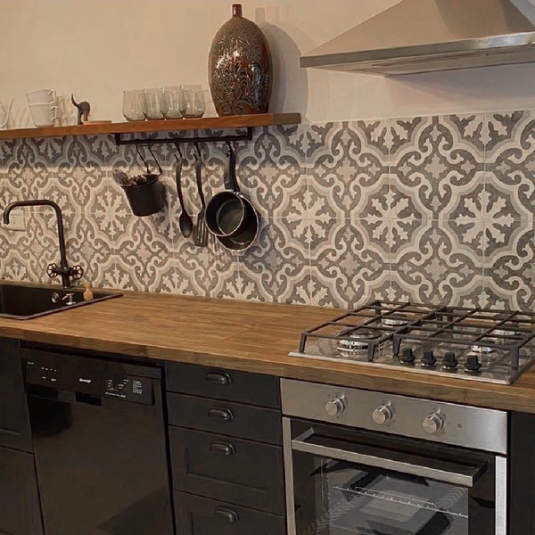 Kitchen splashback tiled floor to shelf in a grey and white floral cement tile pattern