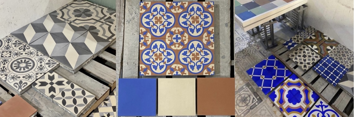 Handmade cement tiles resting on wooden pallets in the Beit Al Ateeq workshop